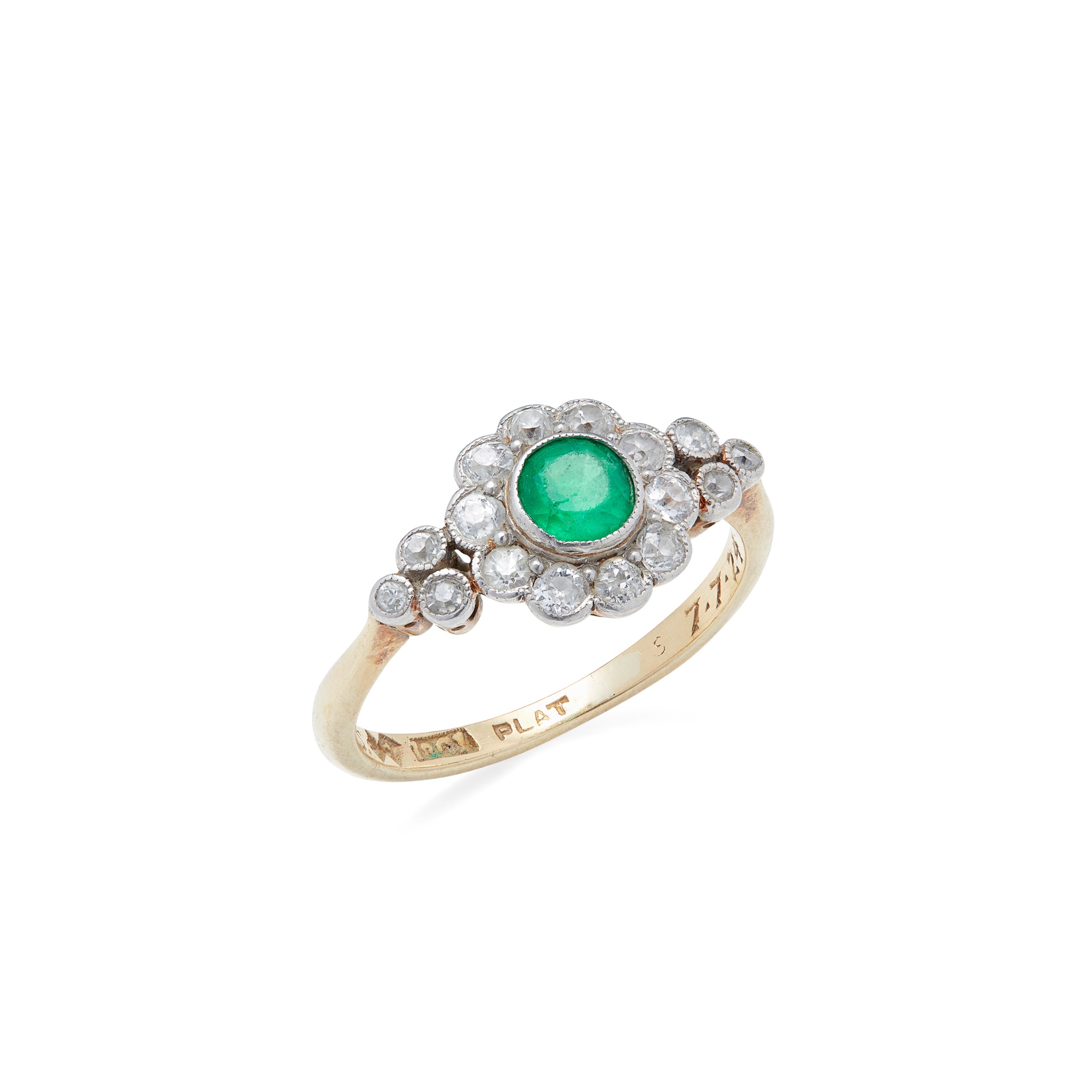 An emerald and diamond set cluster ring