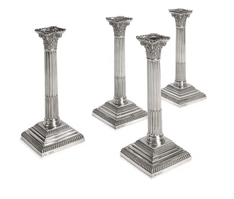 A set of four Edwardian candlesticks,