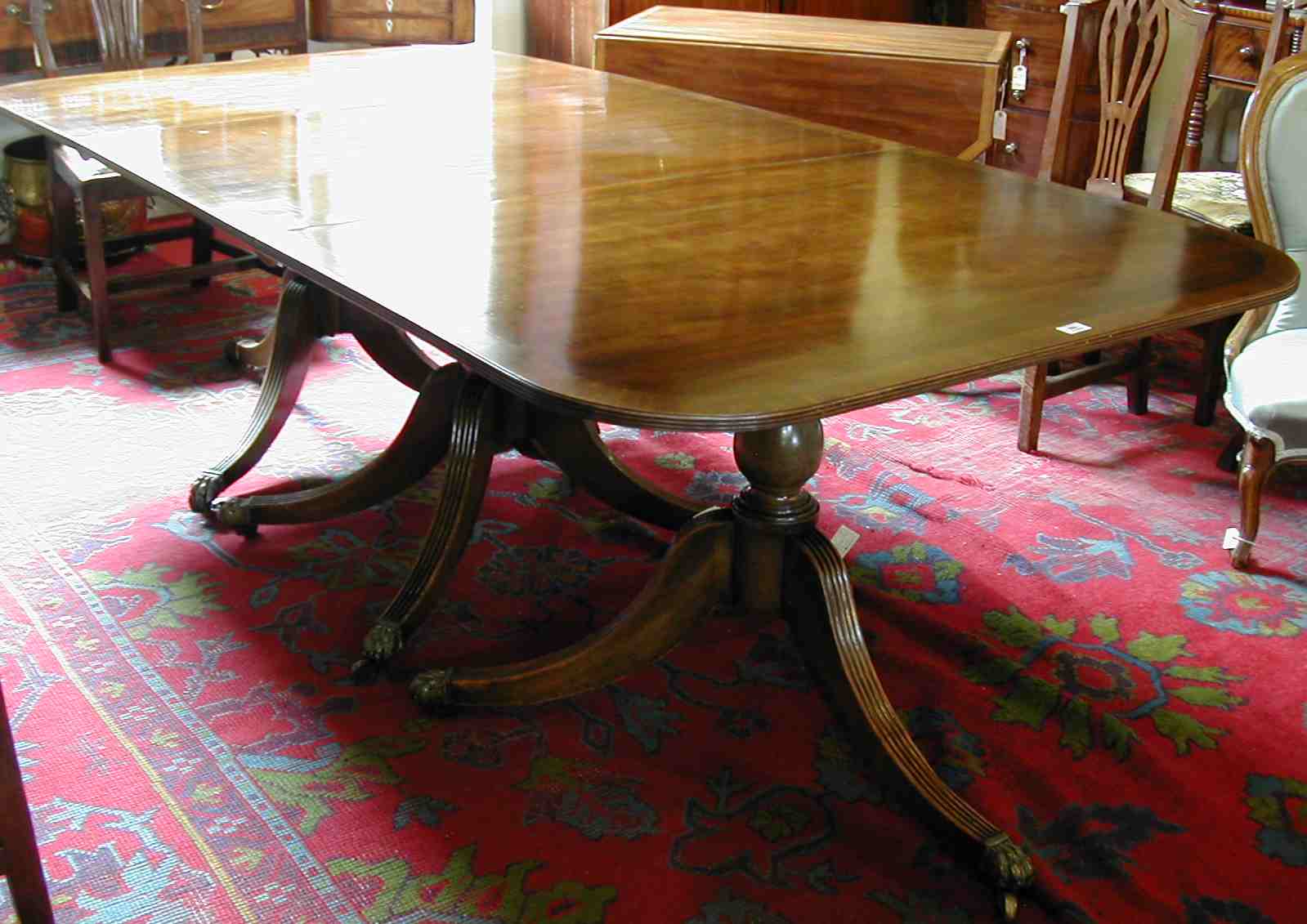A Regency style mahogany triple pedestal dining table,