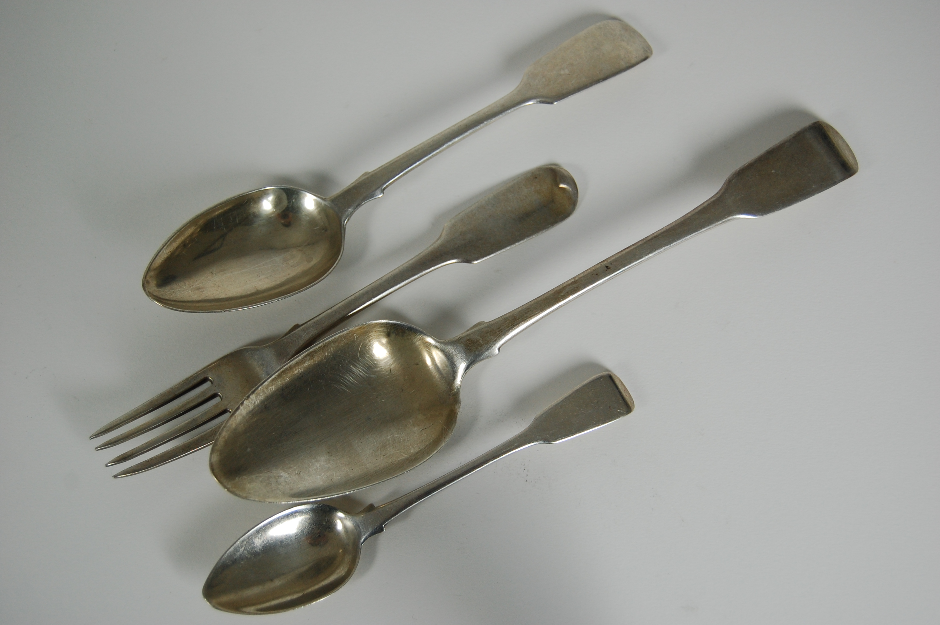 A matched set of silver flatware including;