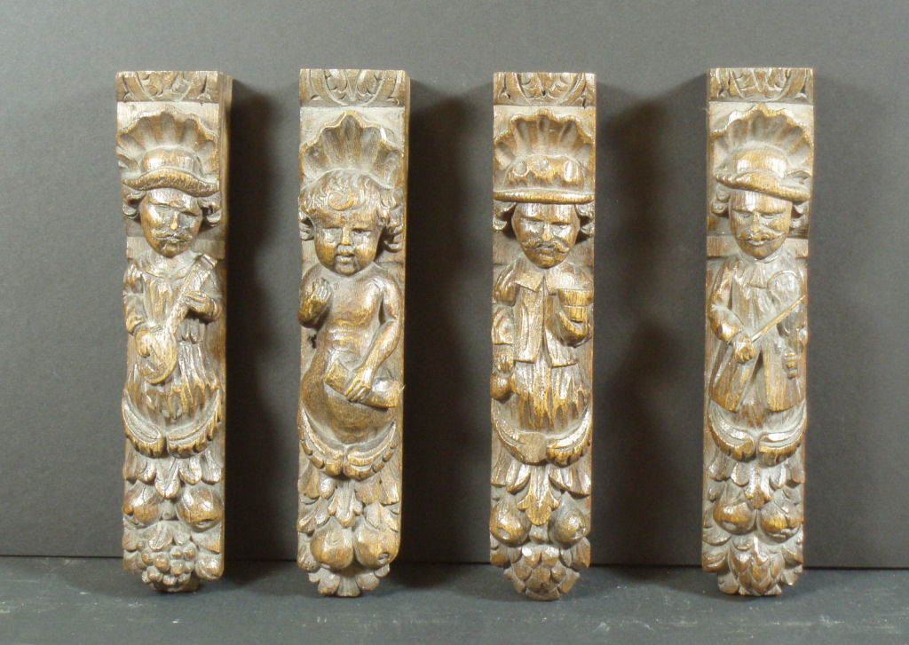 A group of four carved oak caryatids