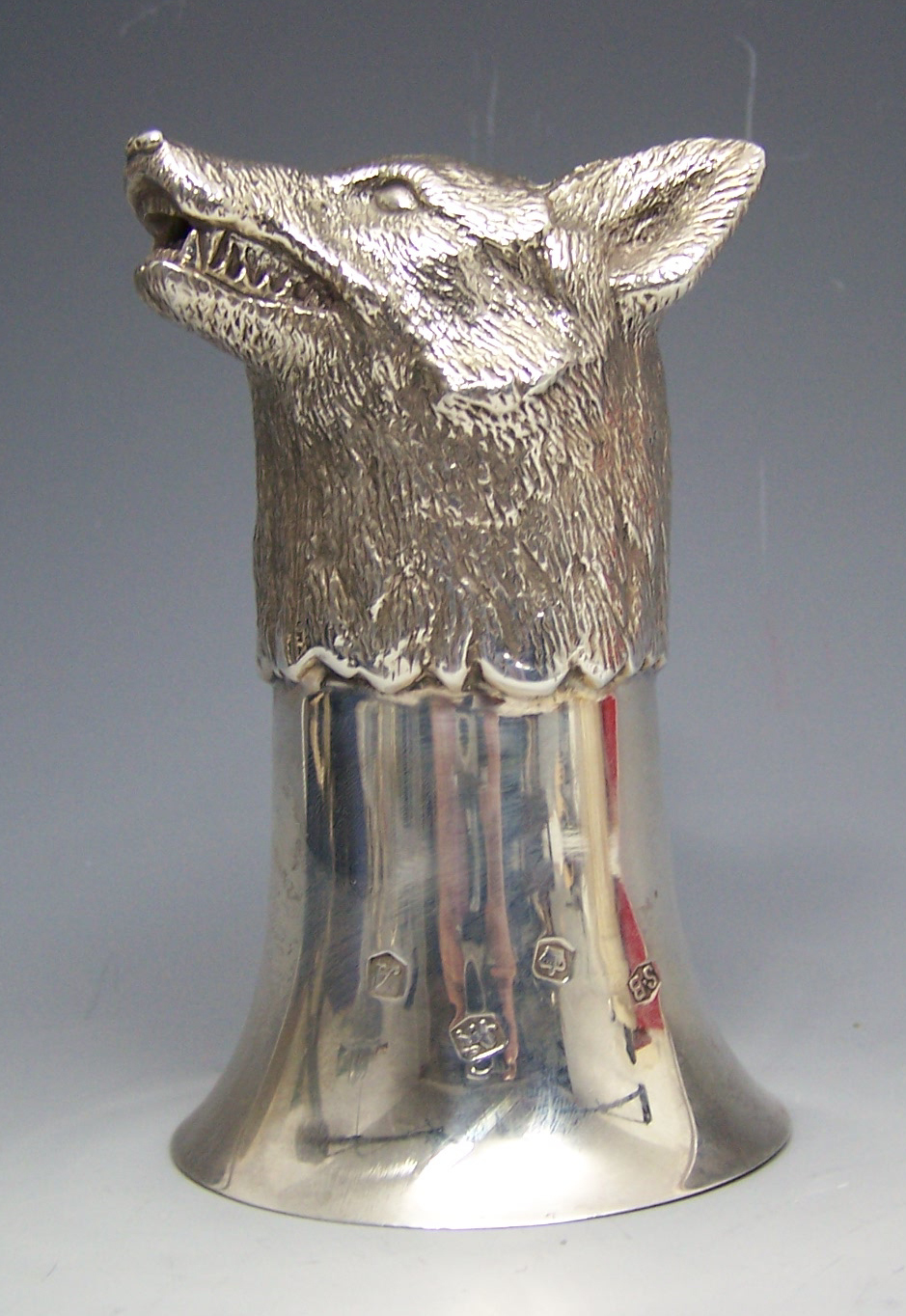 A fox's head stirrup cup,