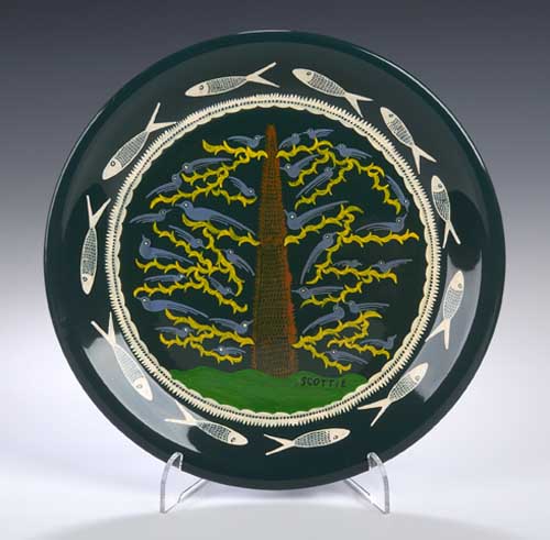 A hand painted circular plate by Scottie Wilson,