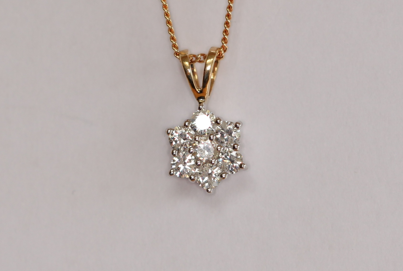 An 18ct two-coloured gold mounted diamond set pendant with chain