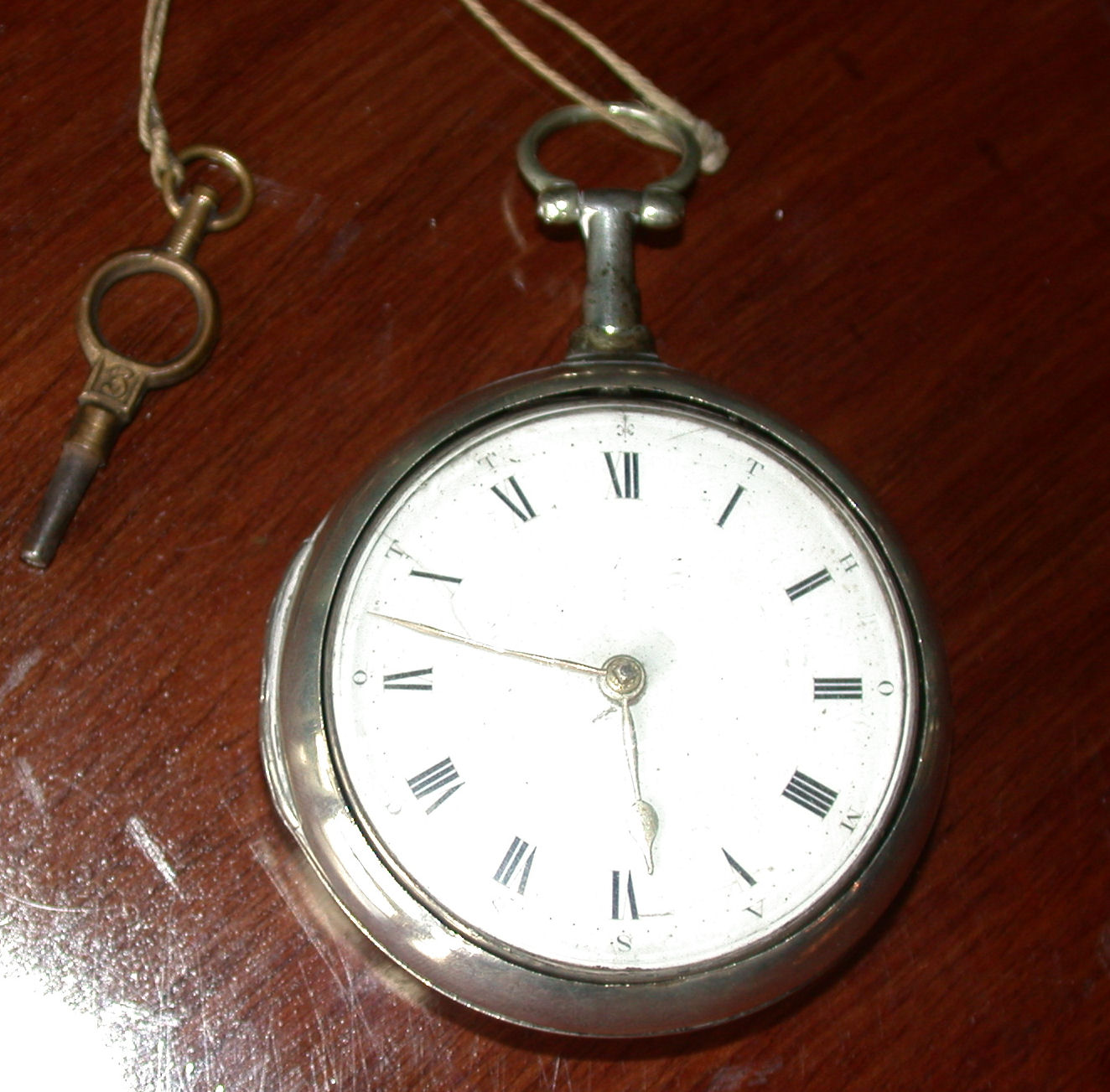 A George III pair cased silver pocket watch,