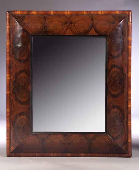 A late 17th century style oyster veneered cushion framed mirror