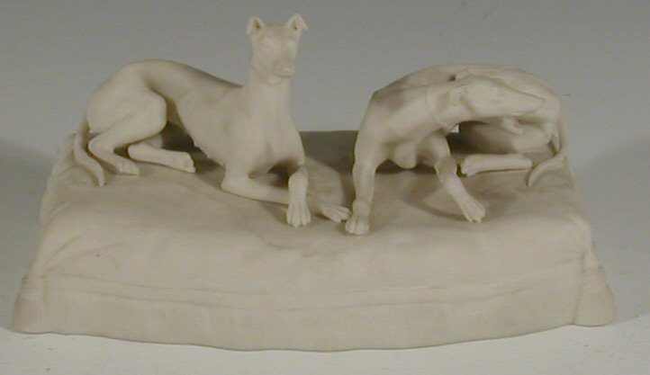 A late 19th century parian ware cast figure of two greyhounds,