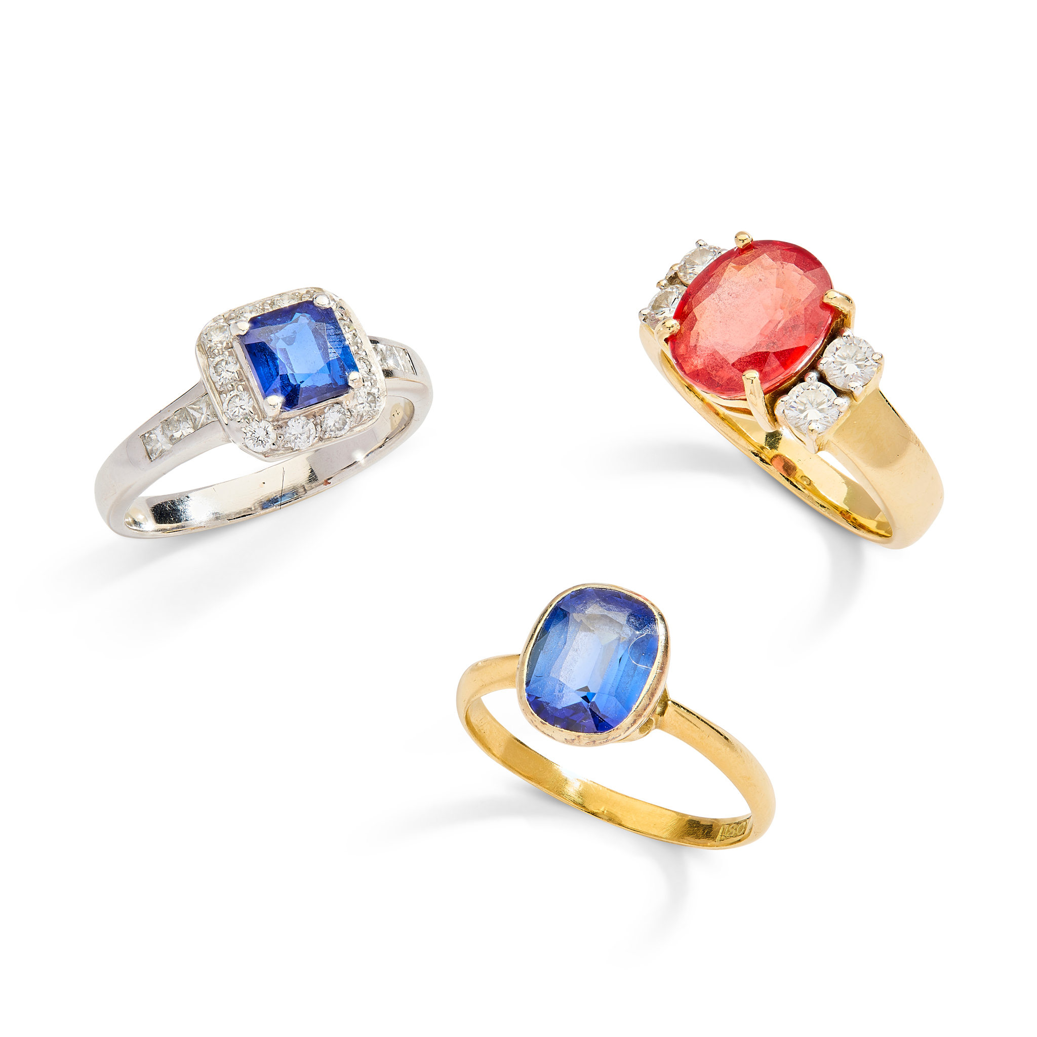 A collection of three synthetic sapphire rings