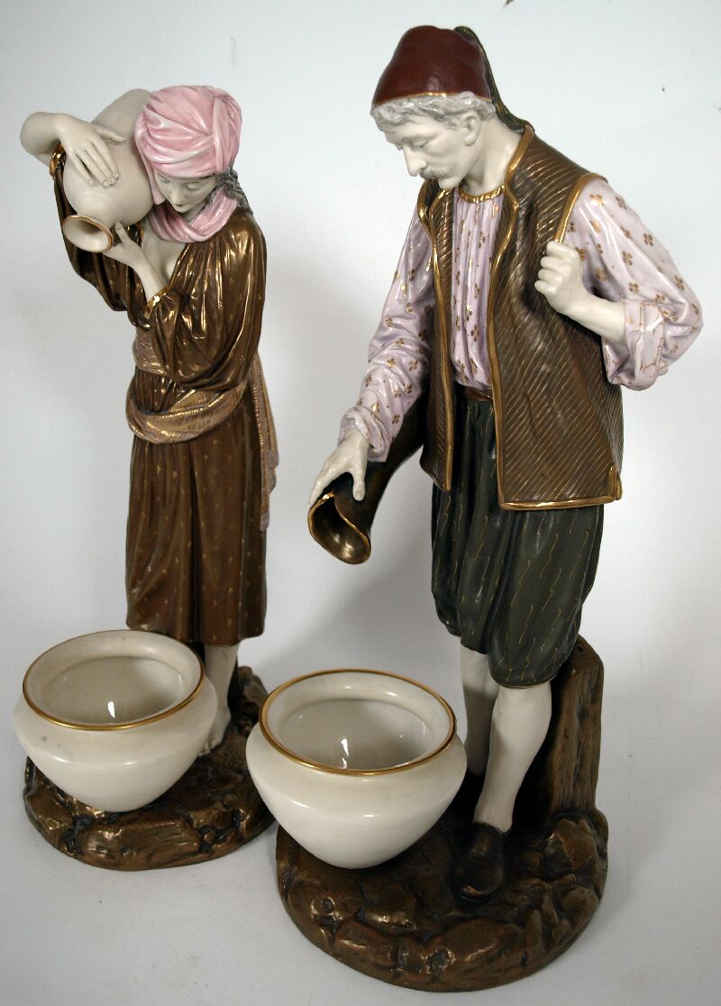A pair of Royal Worcester figures of Eastern water carriers By Hadley