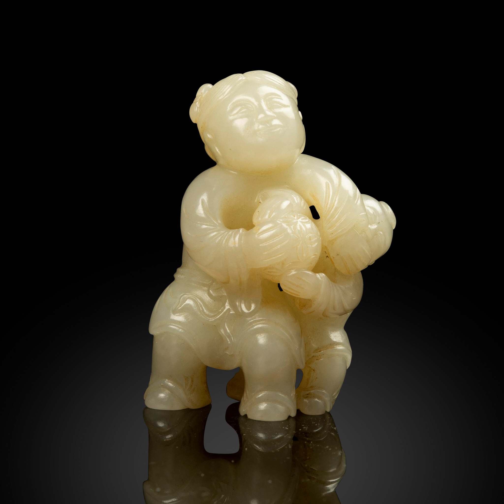 CHINESE WHITE JADE CARVING OF BOYS PLAYING BALL