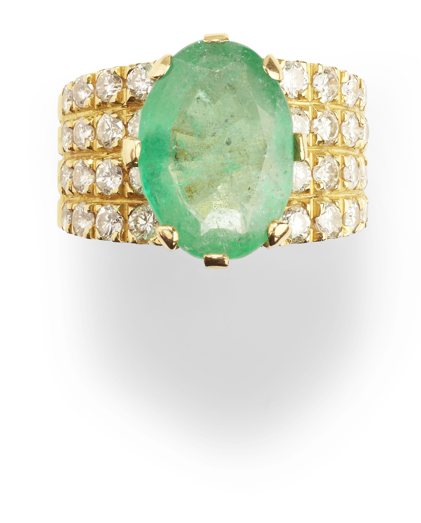 An emerald and diamond cluster ring