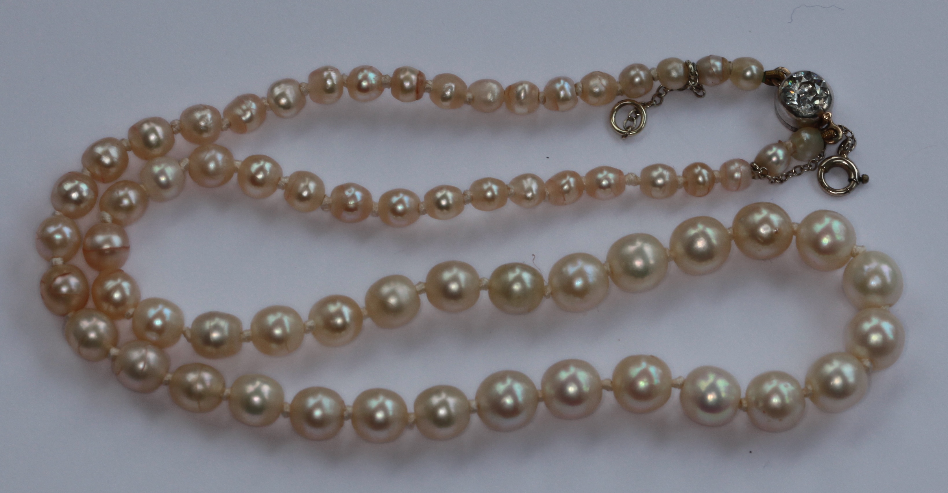 A graduated natural pearl necklace