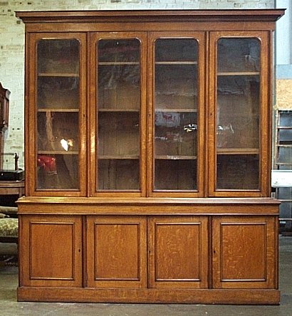 A light oak bookcase on cabinet