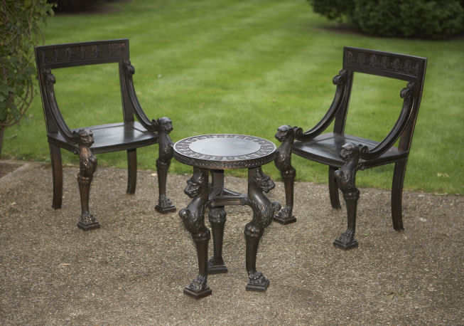 A pair of patinated bronze bergeres and matching centre table