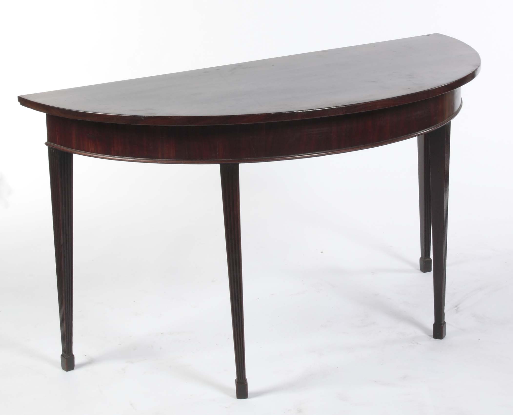 A pair of late George III mahogany demi-lune side tables