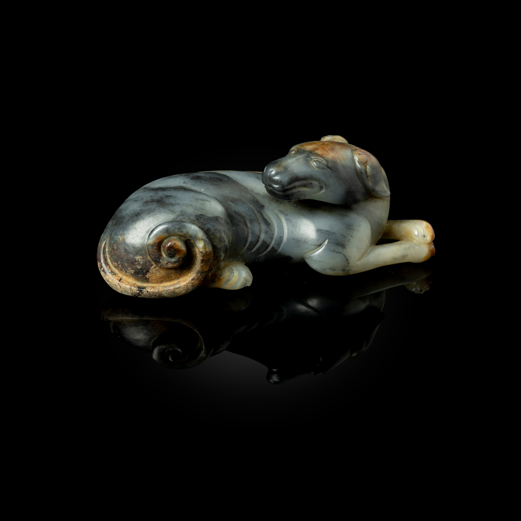 CHINESE WHITE AND BLACK JADE CARVING OF A RECUMBENT DOG