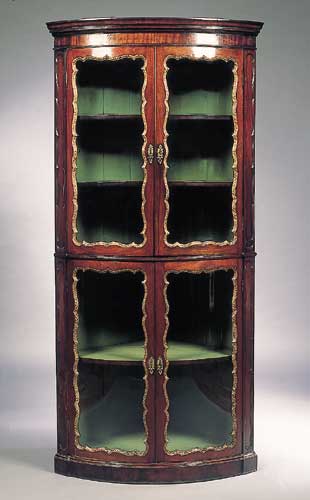 A 19th century George II style mahogany bow front corner cabinet