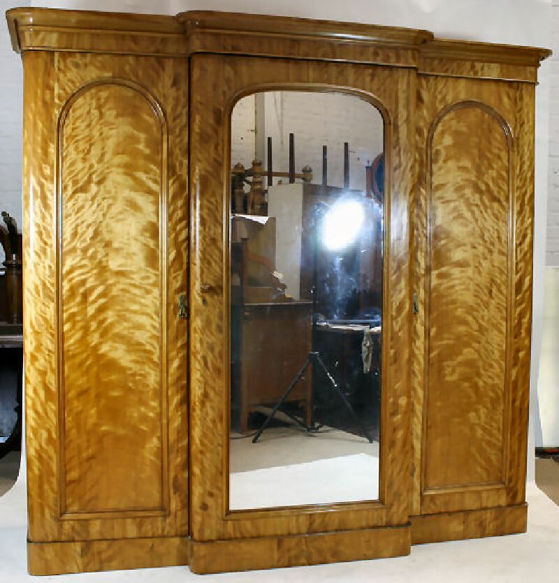 A large Victorian satin birch breakfront wardrobe
