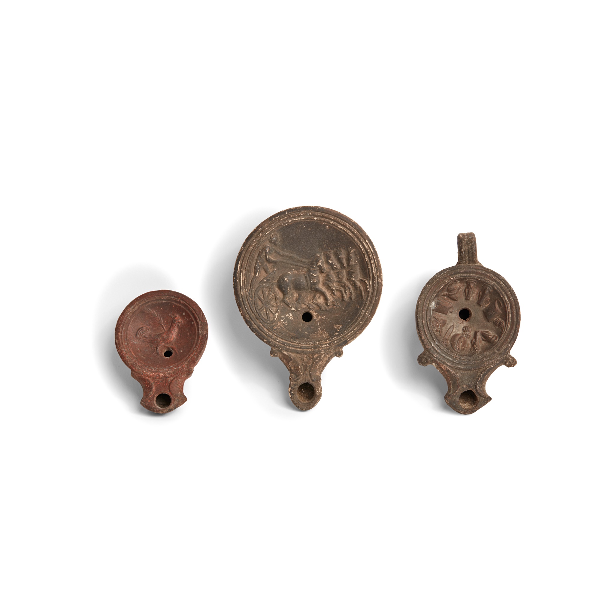 THREE ROMAN OIL LAMPS