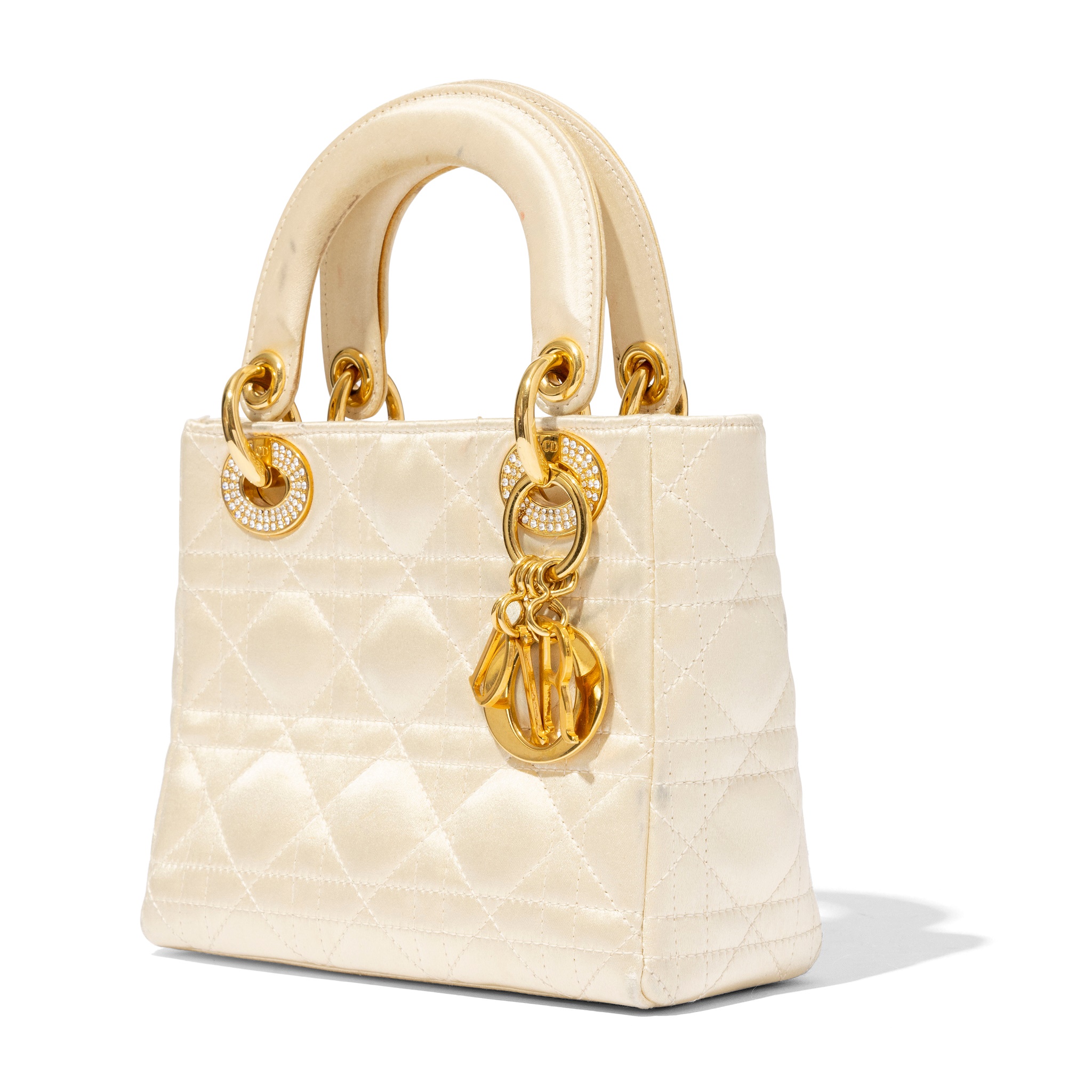 Dior: A cream satin Mini Lady Dior