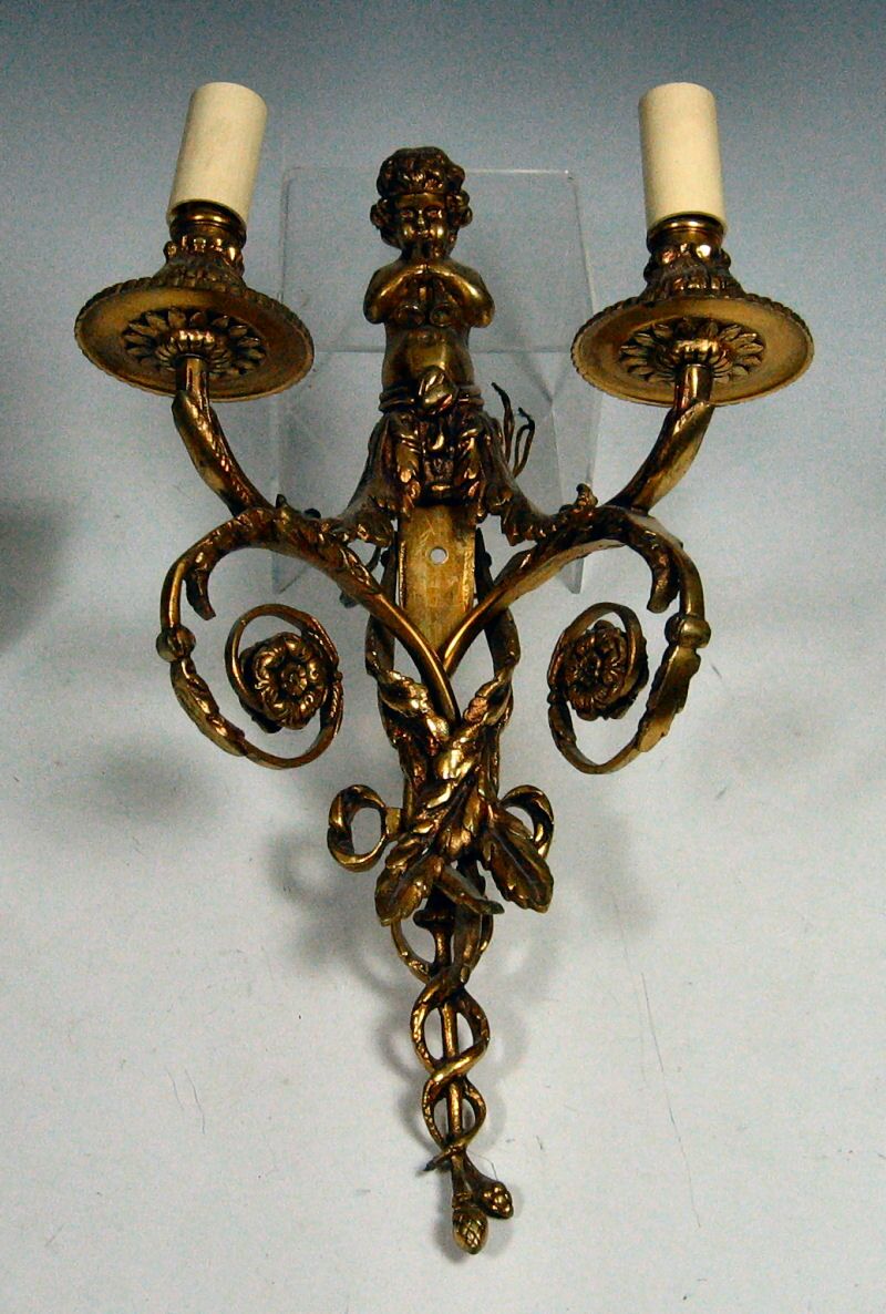 A set of four twin branch gilt wall sconces
