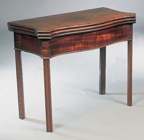 A George III mahogany foldover tea and card table