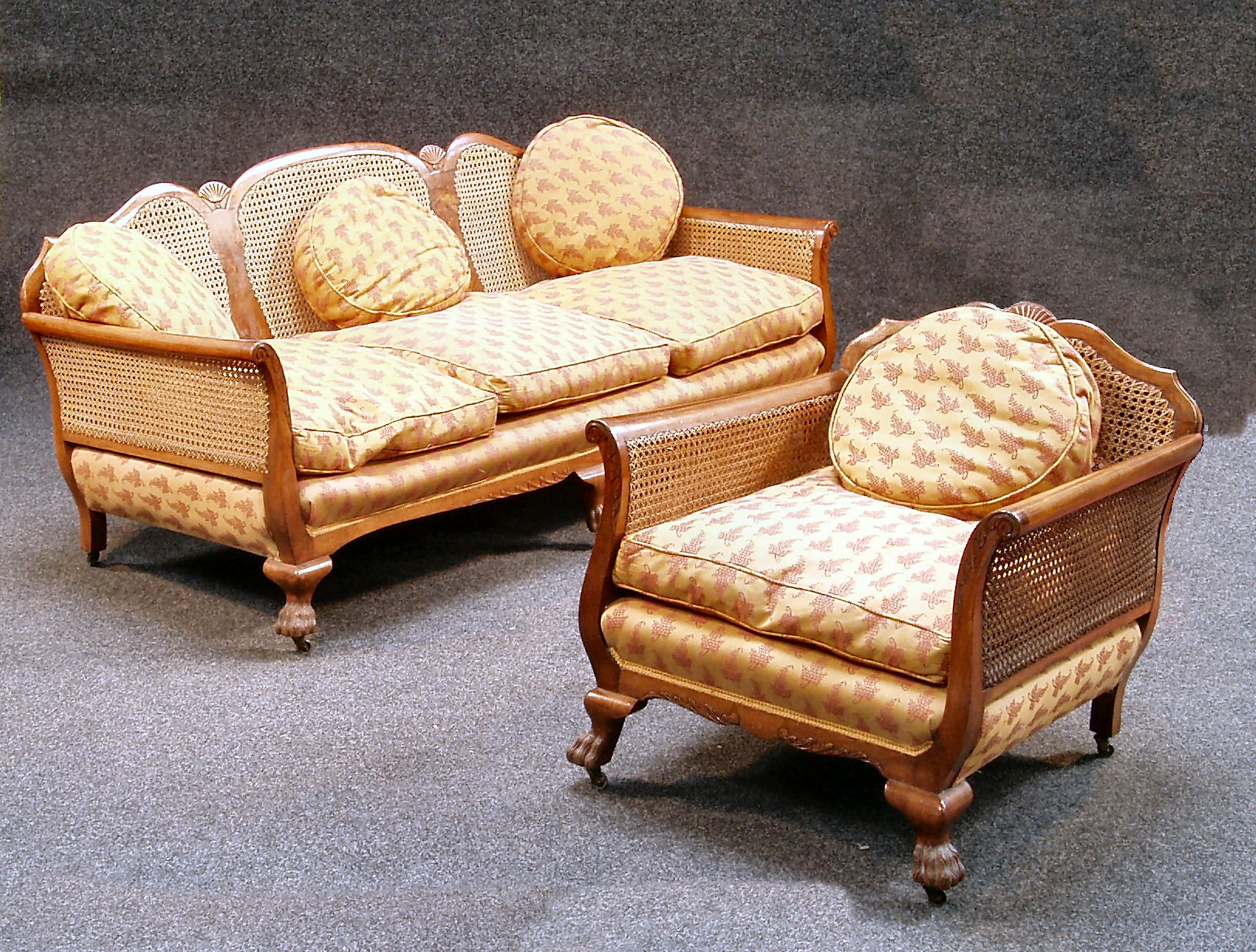 A walnut three piece bergere suite,