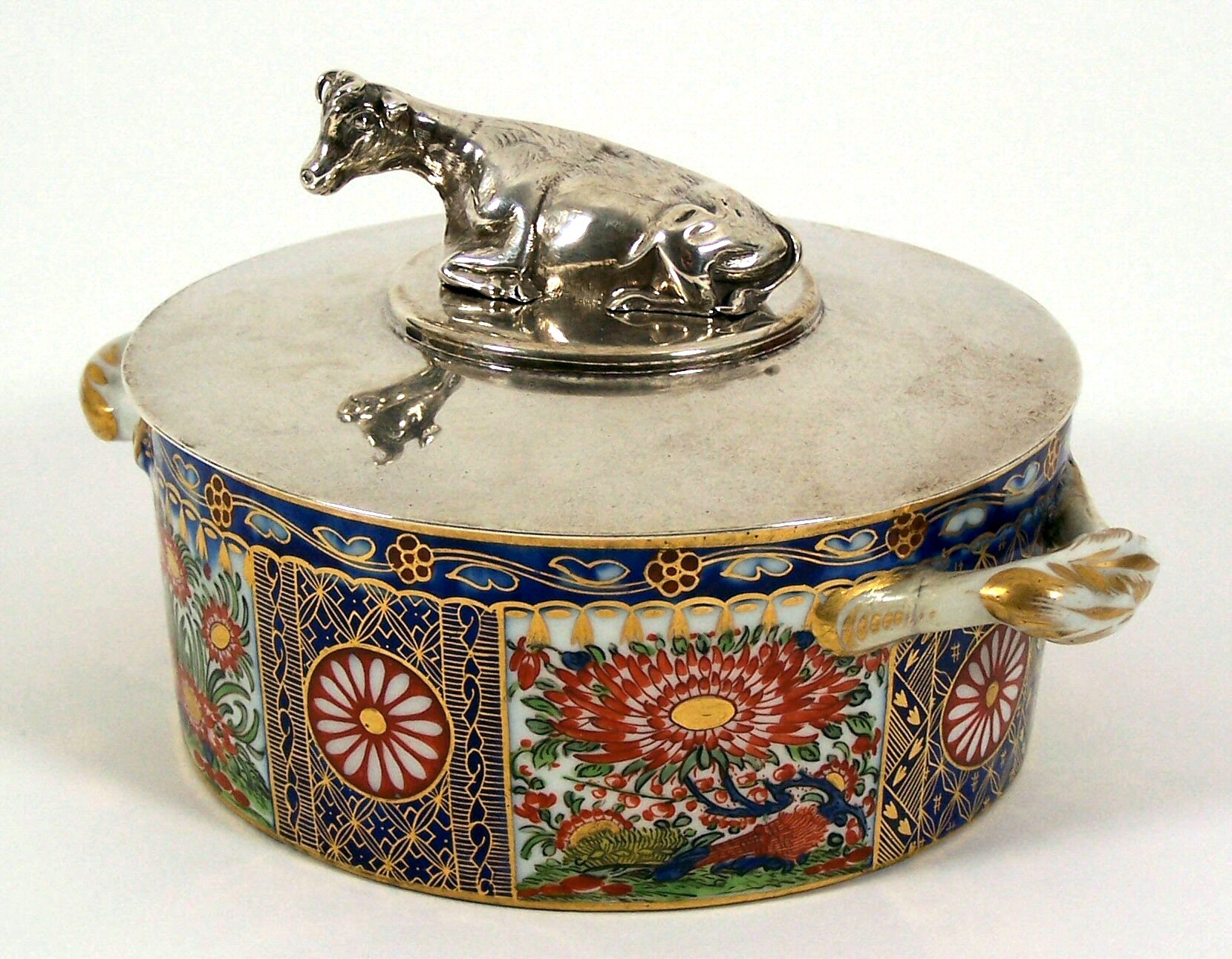 An English 19th century Imari pattern porcelain butter dish and silver cover,