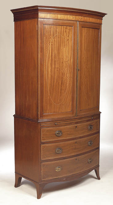 An Edwardian mahogany bowfront linen press,