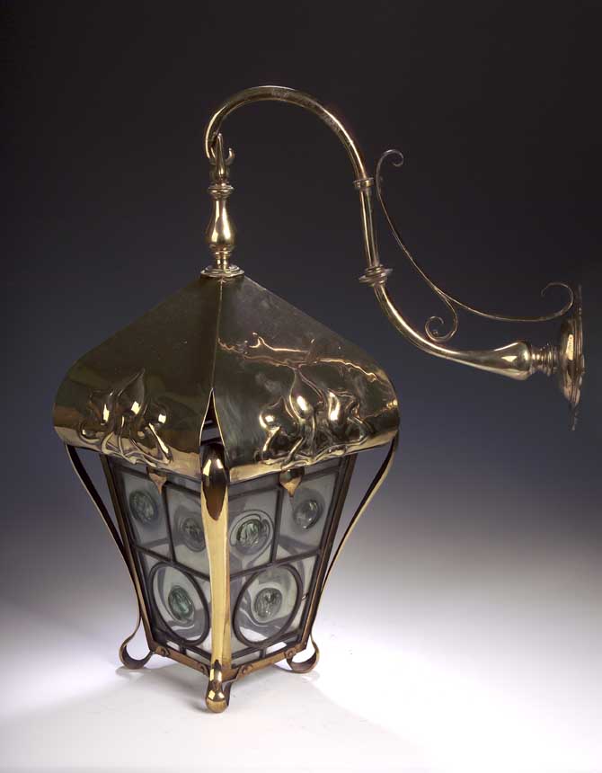 An Arts and Crafts brass hall lantern,