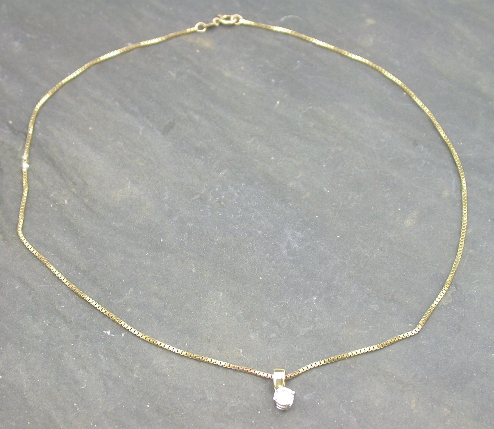 An 18ct gold mounted diamond single stone pendant,