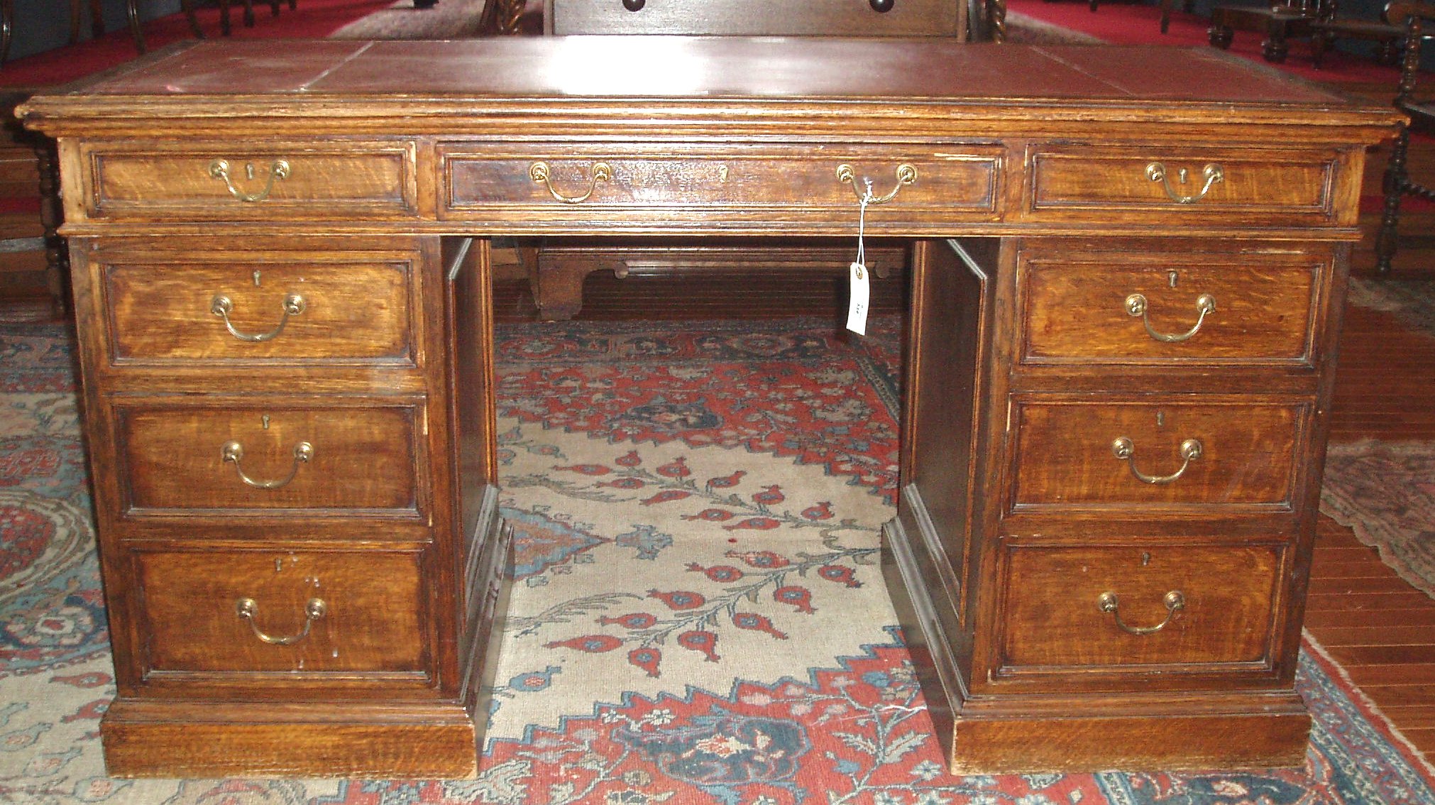 An Edwardian oak twin pedestal desk,
