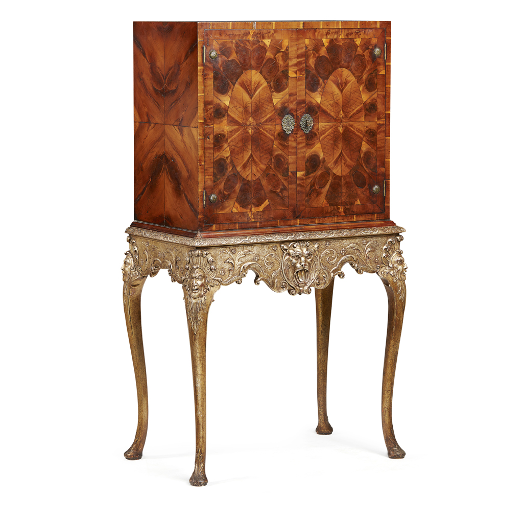 GEORGE I STYLE OYSTER VENEERED AND PARCEL GILT CABINET ON STAND