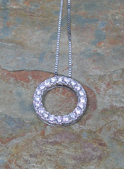 A diamond set circular pendant,