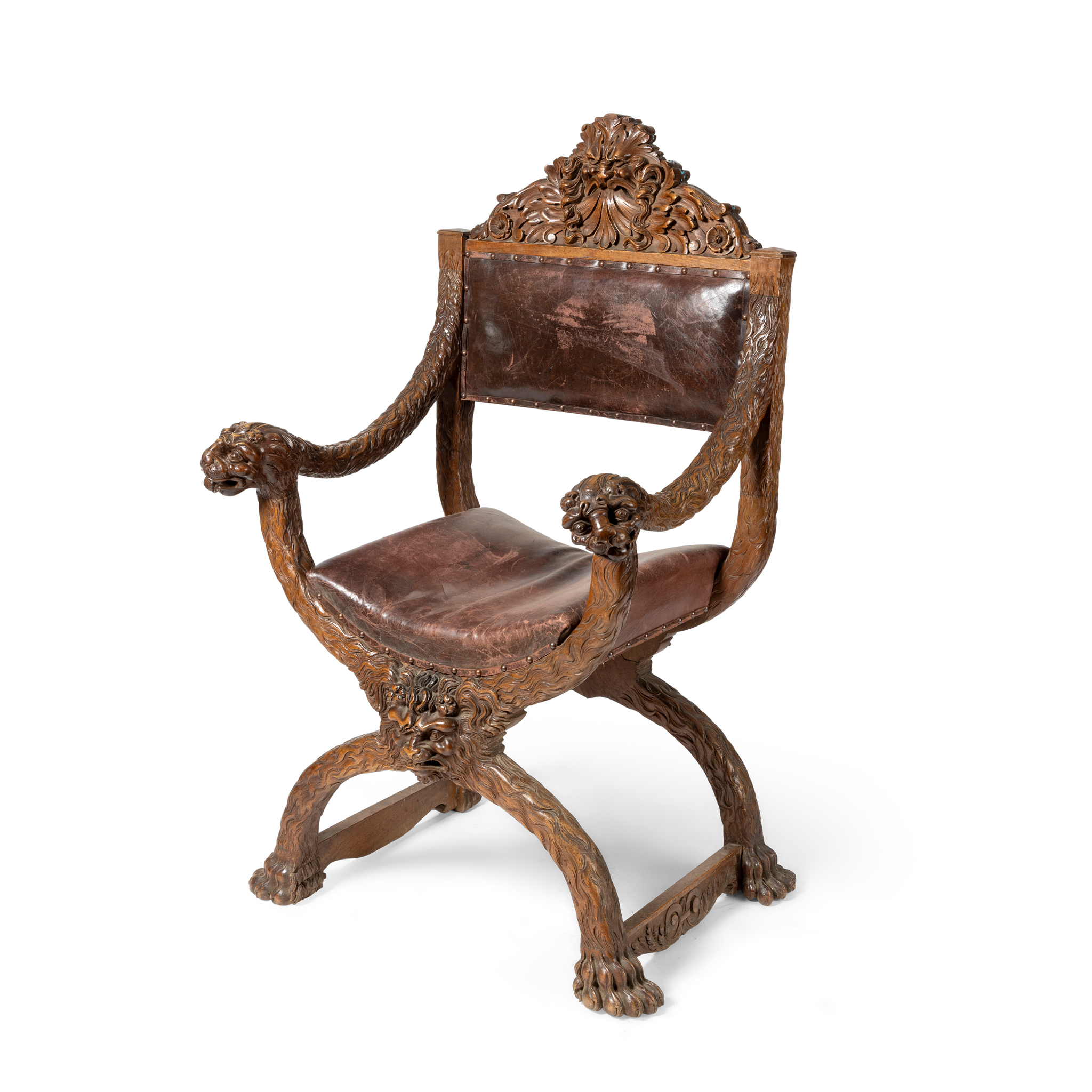 AN ITALIAN CARVED WALNUT X-FRAME ARMCHAIR
