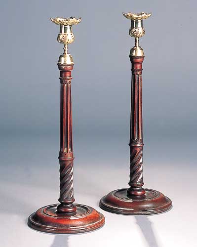 A pair of George III mahogany candlesticks