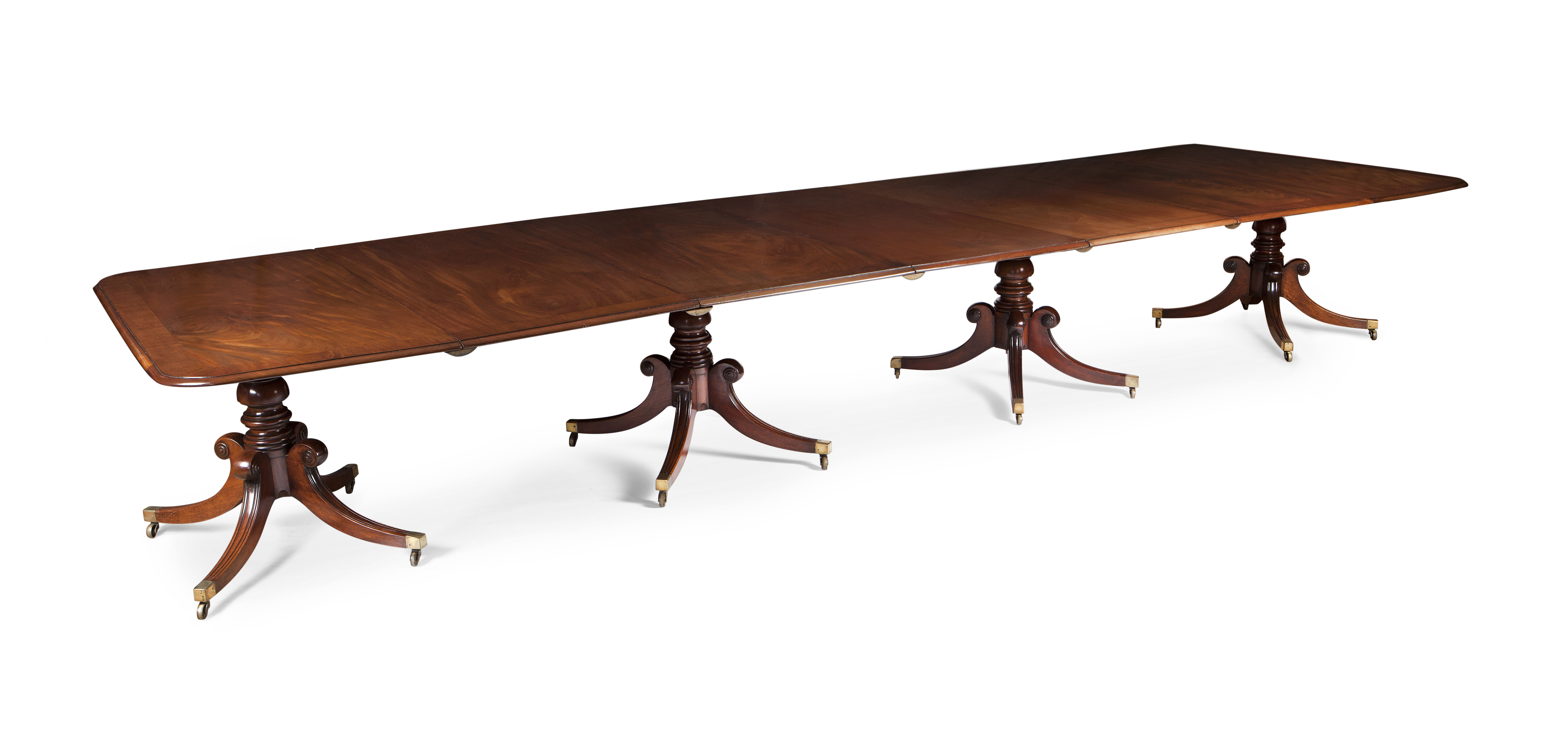 FINE REGENCY MAHOGANY AND CROSSBANDED FOUR PILLAR DINING TABLE