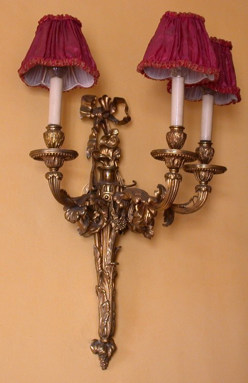 A set of SIX Louis XV style gilt bronze three branch wall lights