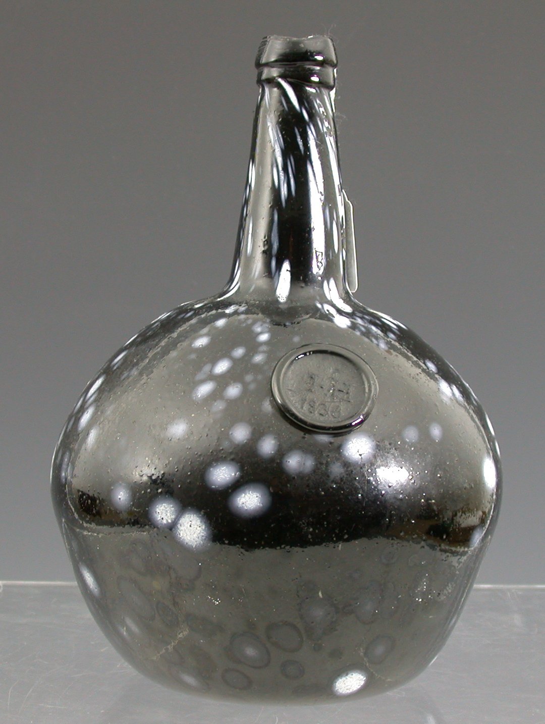 A dated Nailsea type onion shaped wine flask
