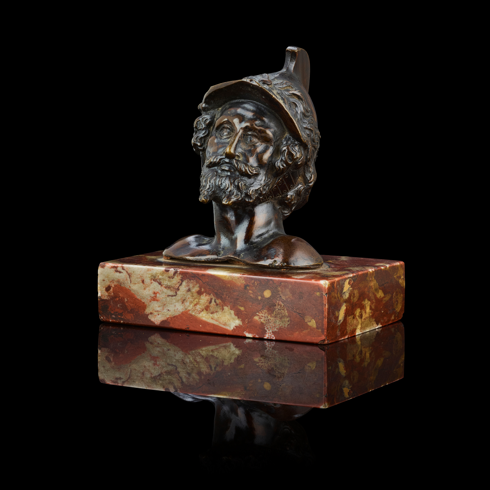 AN ITALIAN BRONZE HEAD OF A HELMETED WARRIOR