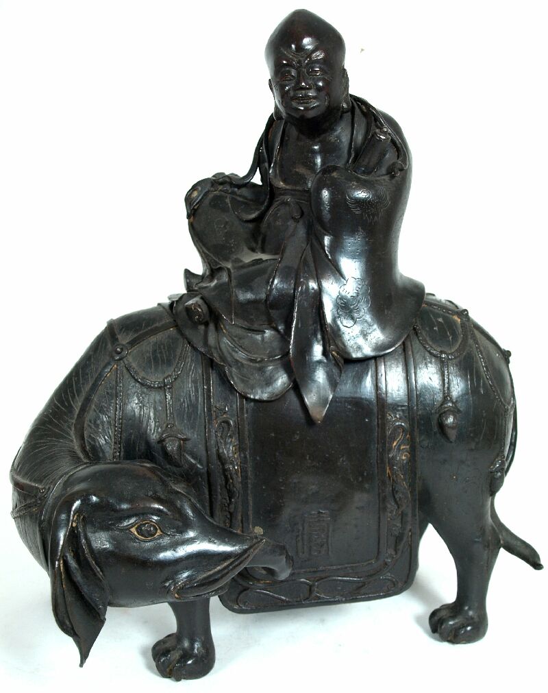 A Chinese bronze figure of an Immortal riding an elephant