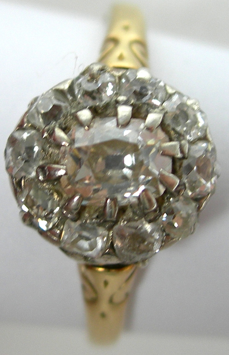 An 18ct gold mounted diamond cluster ring,