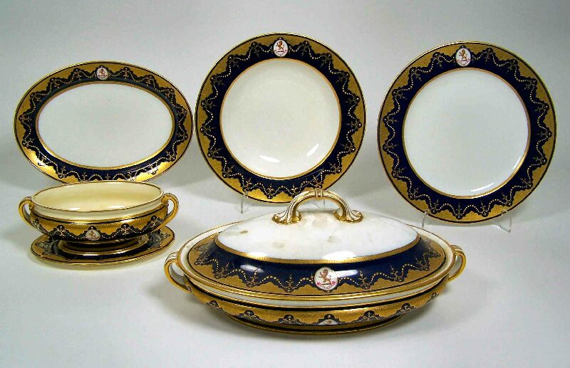 An early 20th century Mintons Armorial part dinner service