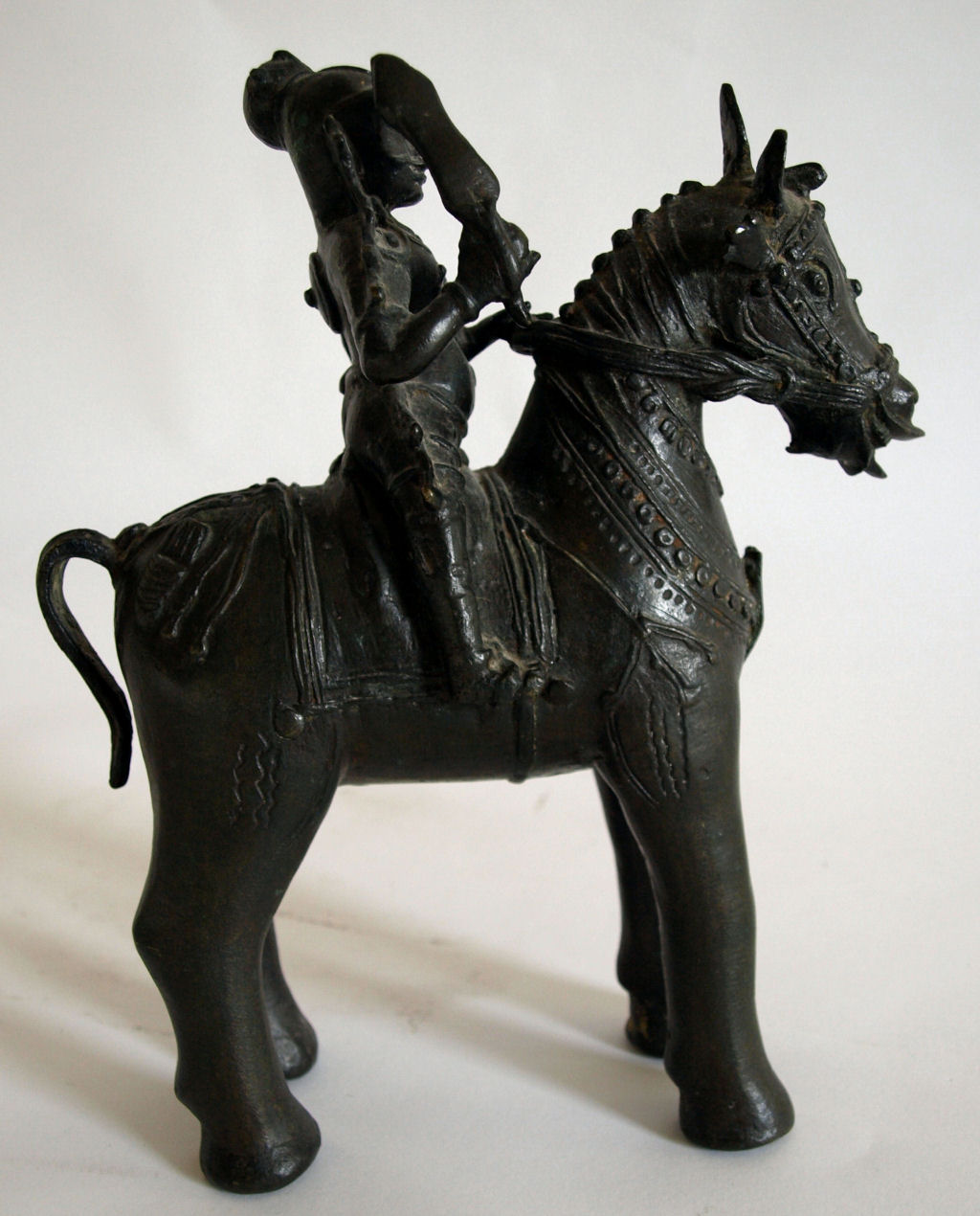 A 19th century Indian bronze figure of a warrior on horseback, probably Kanataka