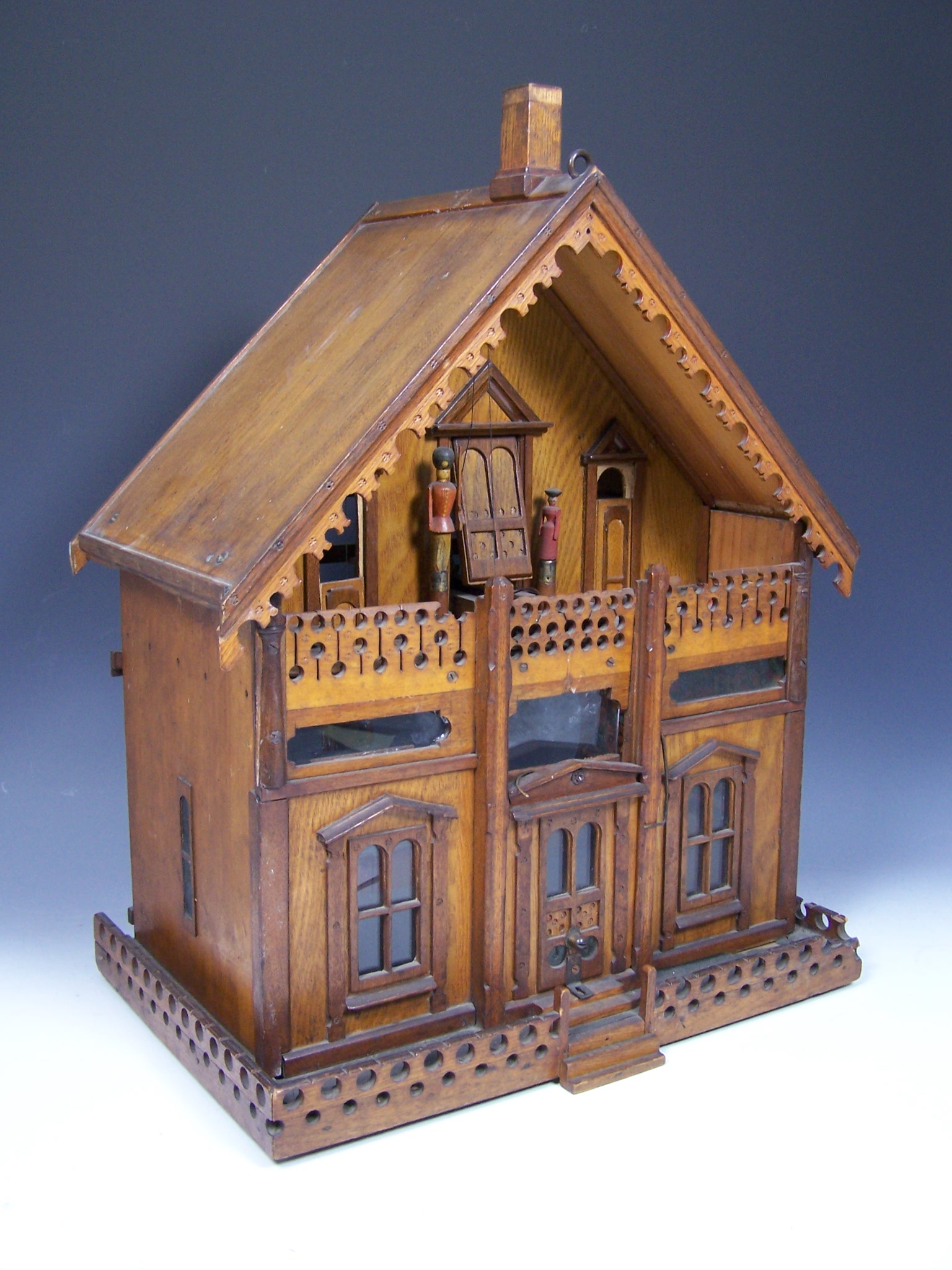 An unusual late 19th century continental oak automata doll's house