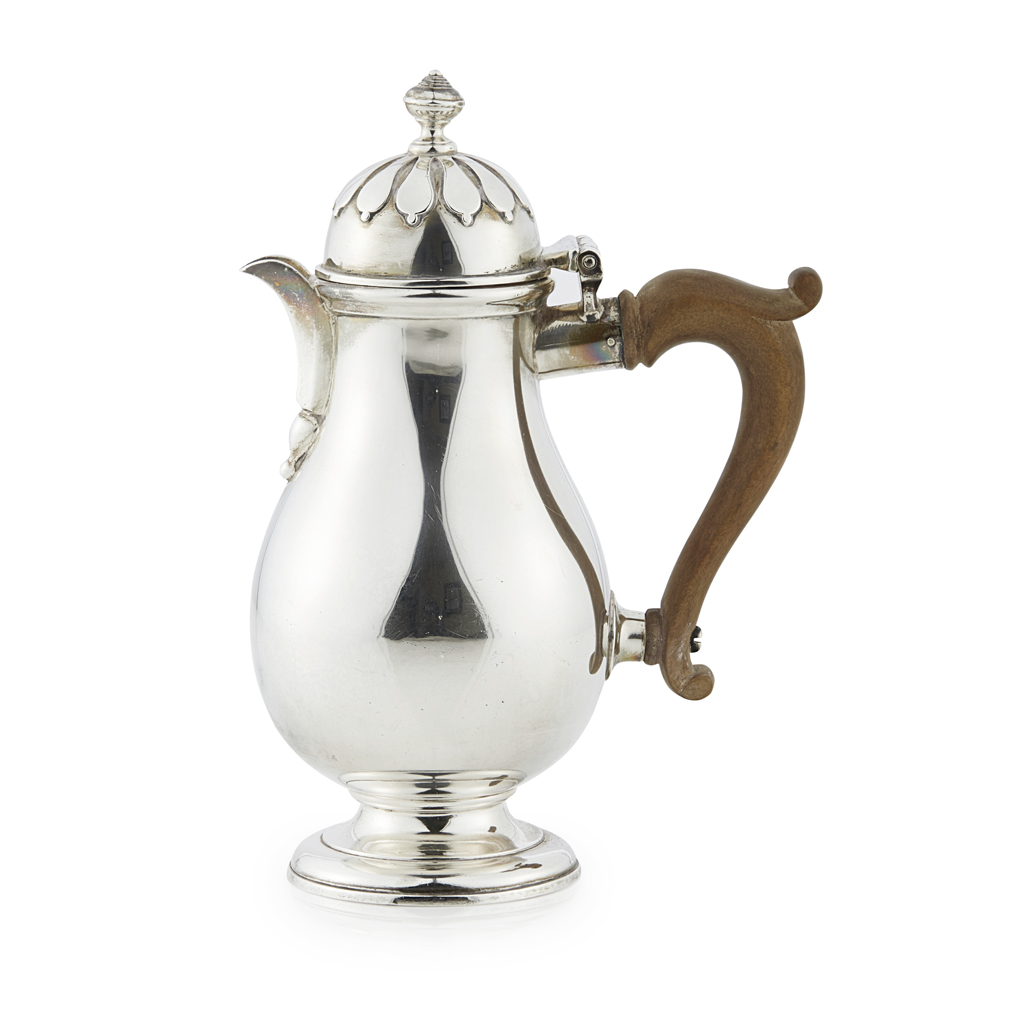 A collection of flatware and a water pot