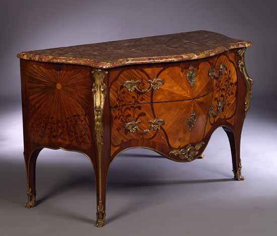A Louis XV style gilt bronze mounted tulip wood and purpleheart bombe commode