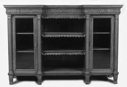 An Edwardian oak reverse breakfront bookcase
