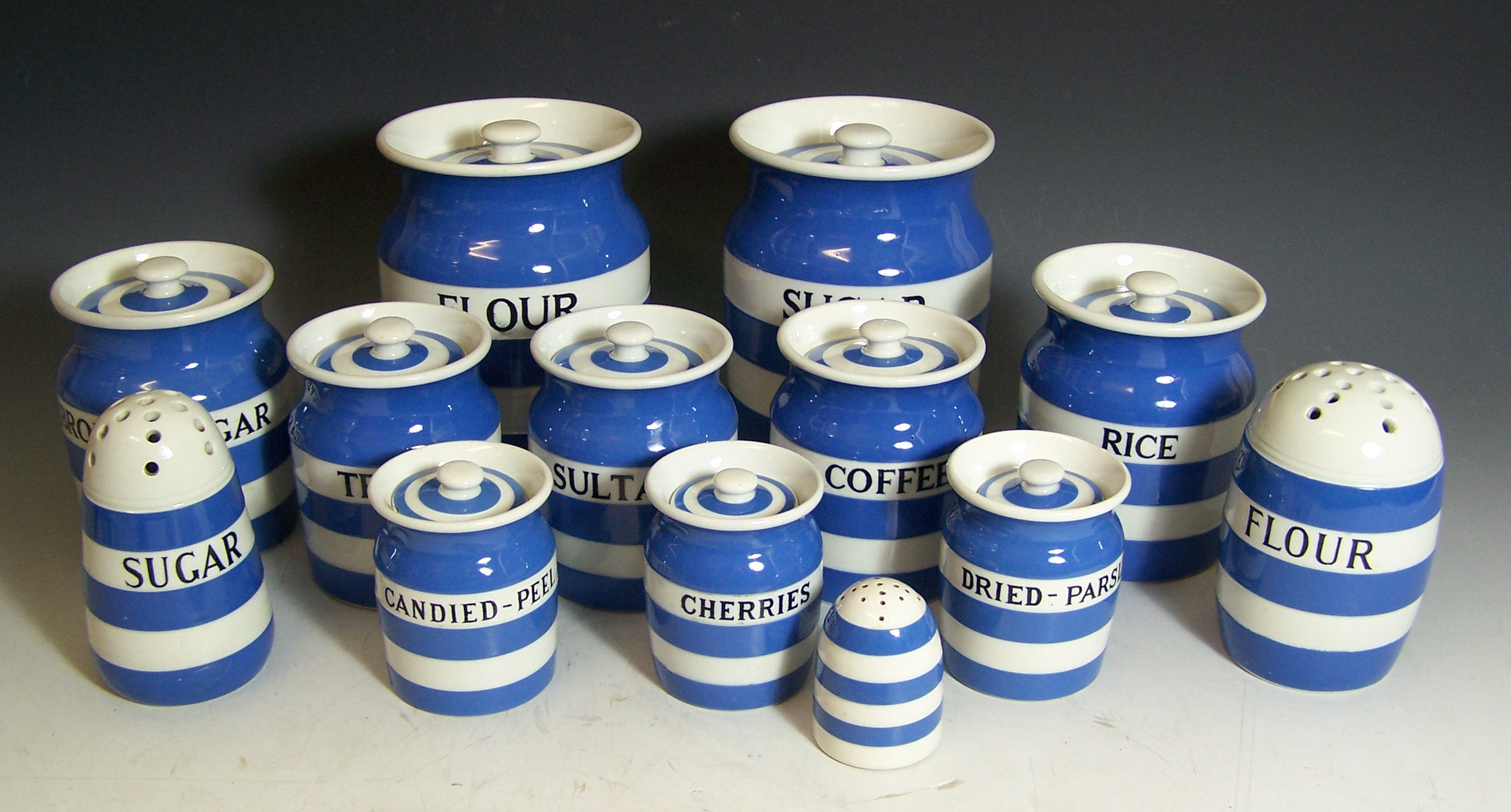 A collection of blue and white striped Cornish Kitchen Ware,