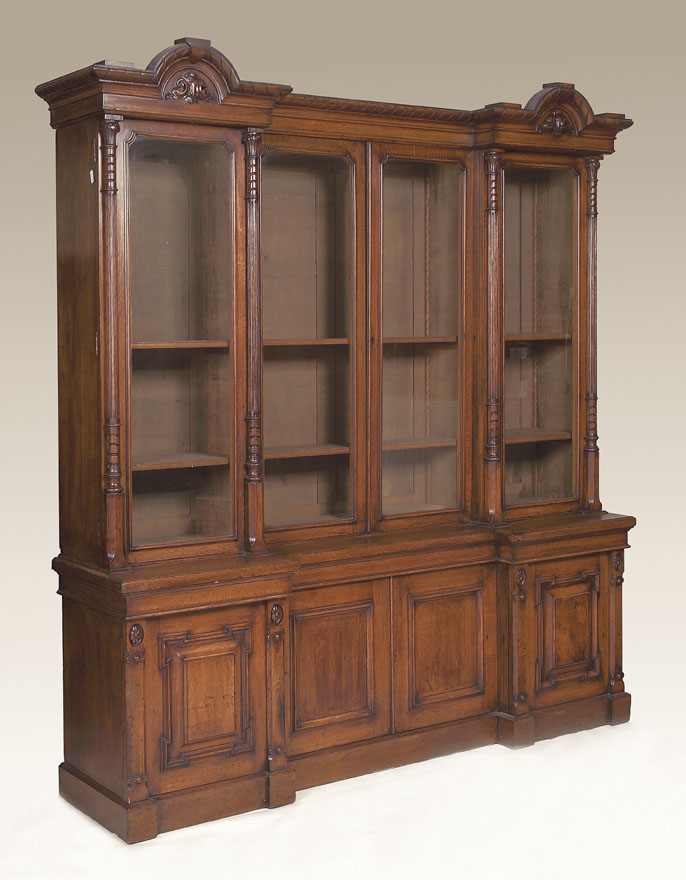 A late 19th century oak reverse breakfront bookcase,